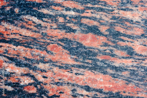 Facing wall of curly pieces of marble. Basement of the building