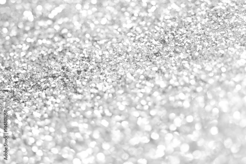 Sillver bokeh texture. Festive glitter background with defocused lights