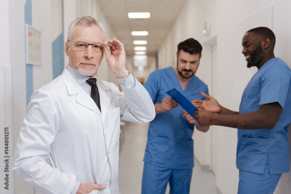 Fototapeta premium Charismatic aging medic demonstrating confidence at work