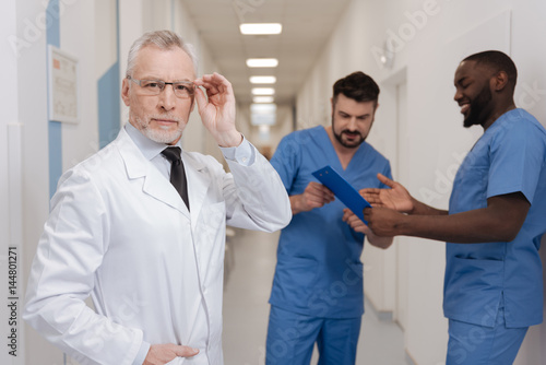 Charismatic aging medic demonstrating confidence at work