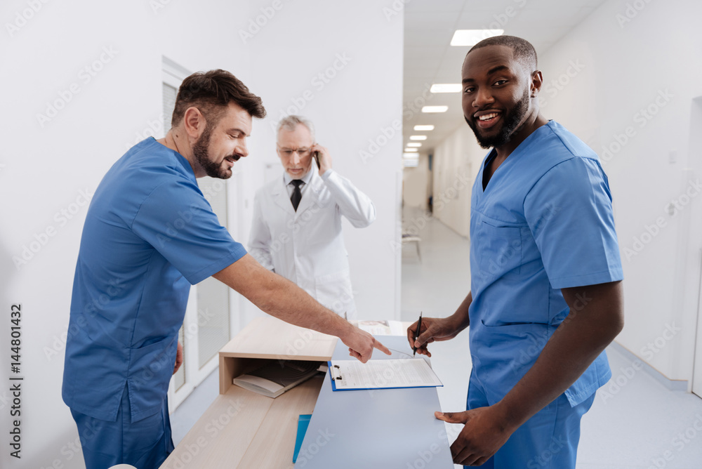 Obraz premium Positive practitioners working in the clinic