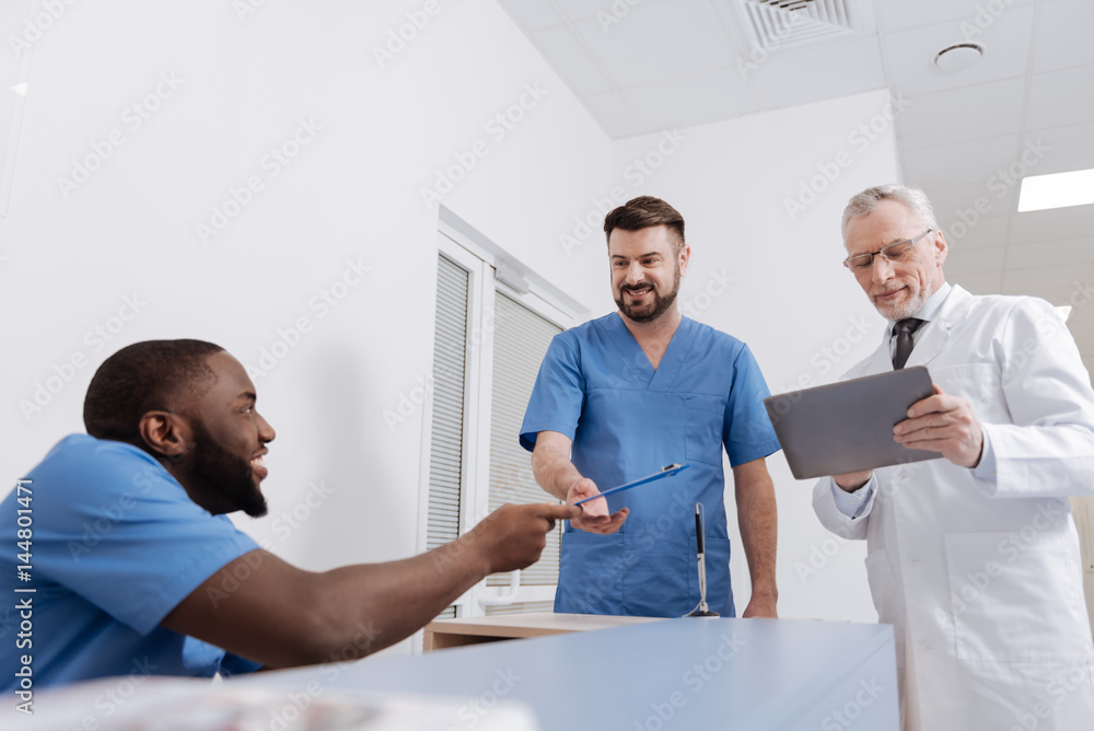 Fototapeta premium Friendly medical colleagues sharing news in the hospital