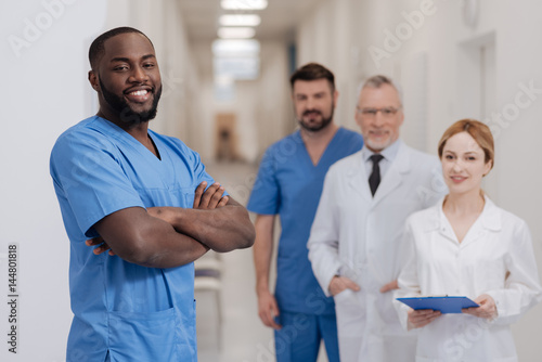 Cheerful African American intern expressing happiness in the hospital