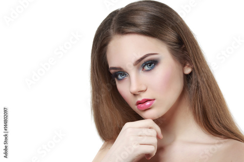 Beauty portrait of a beautiful girl with a bright make-up and long hairmelted over white background.
