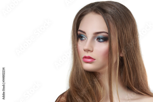 Beauty portrait of a beautiful girl with a bright make-up and long hairmelted over white background.