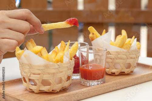 Obraz na płótnie Eating french fries dipping with ketchup and chili sauce w salonie