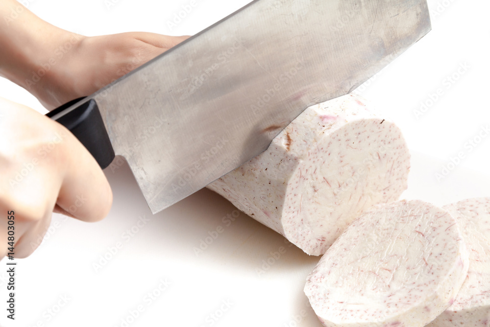 Cutting raw taro with knife