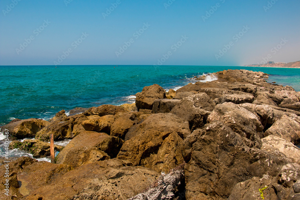 Beautiful seashore with breakwater and large stones