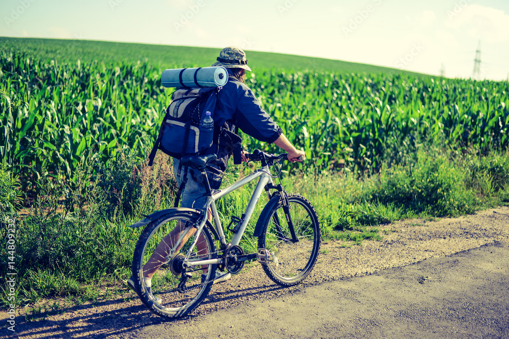 Obraz premium hipster man on a bicycle in the countryside