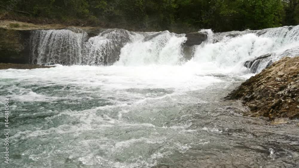 Wide shot of slow motion water floating down a cascade of a river, in 4K Wide shot of slow motion water floating down a cascade of a river, in 4K