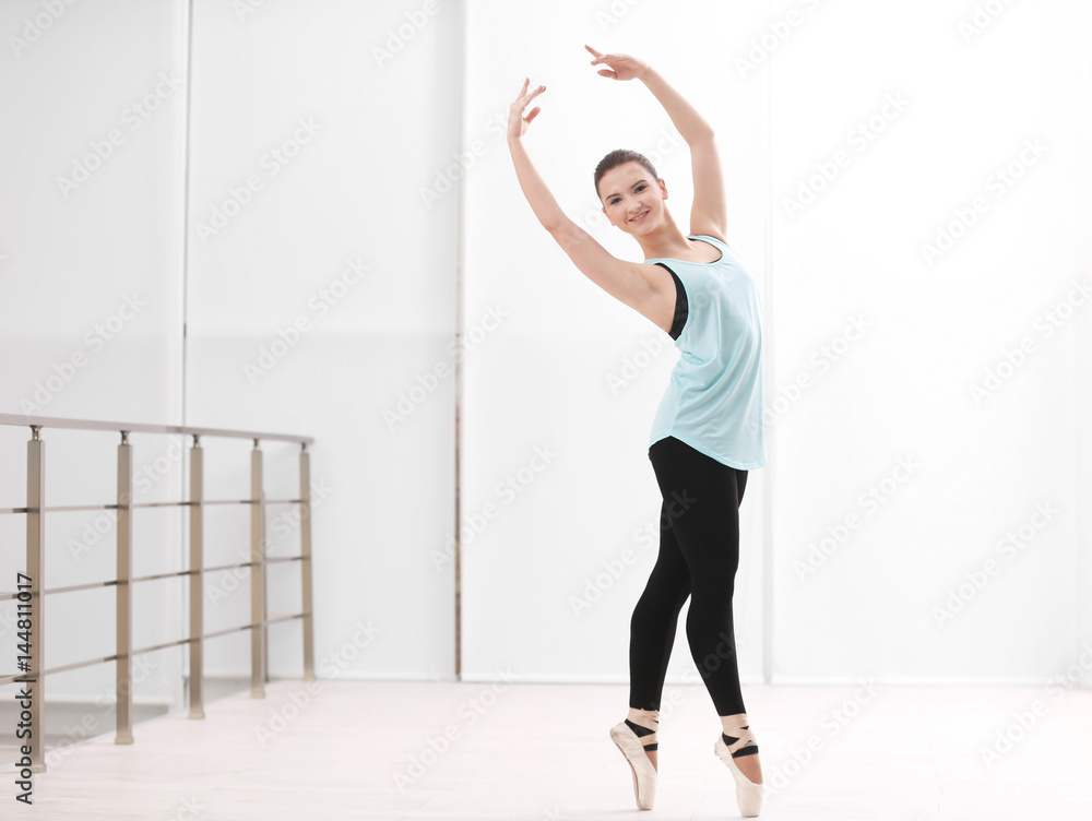 Ballet art concept. Young beautiful ballerina training in dance hall Ballet art concept. Young beautiful ballerina training in dance hall
