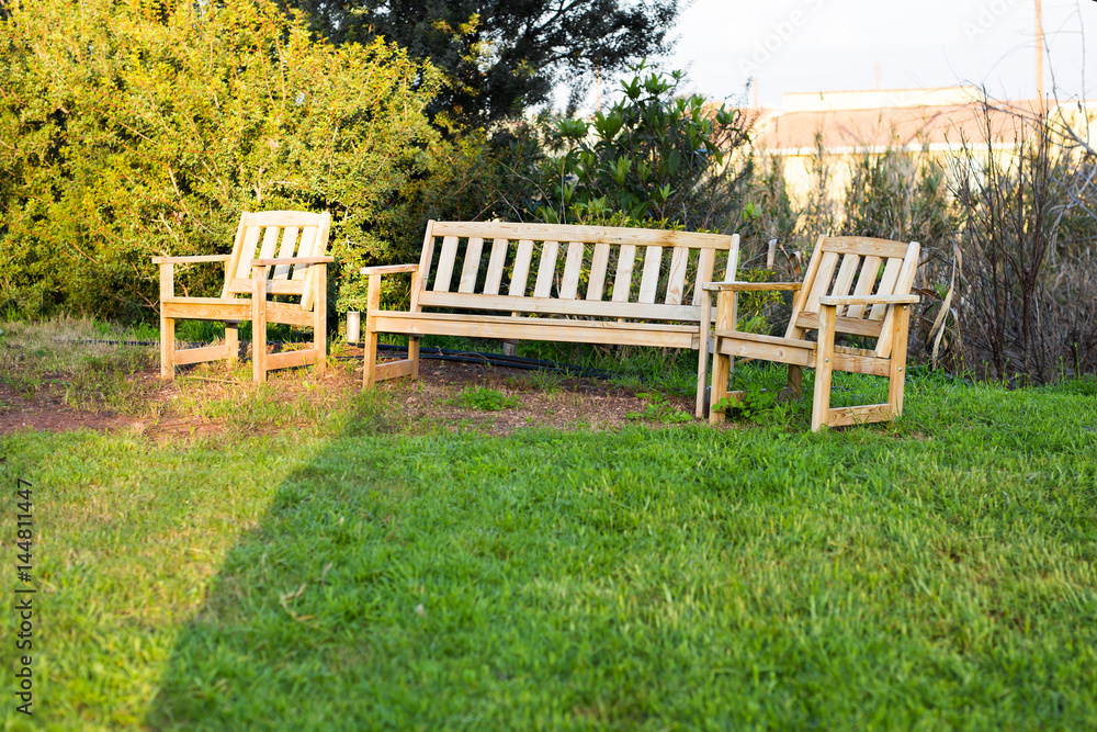 Wooden outdoor furniture. Lounge chairs in hotel garden invite you to relax Wooden outdoor furniture. Lounge chairs in hotel garden invite you to relax