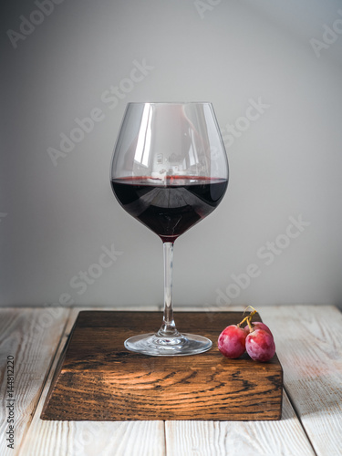 Glass of wine on wood cutting board