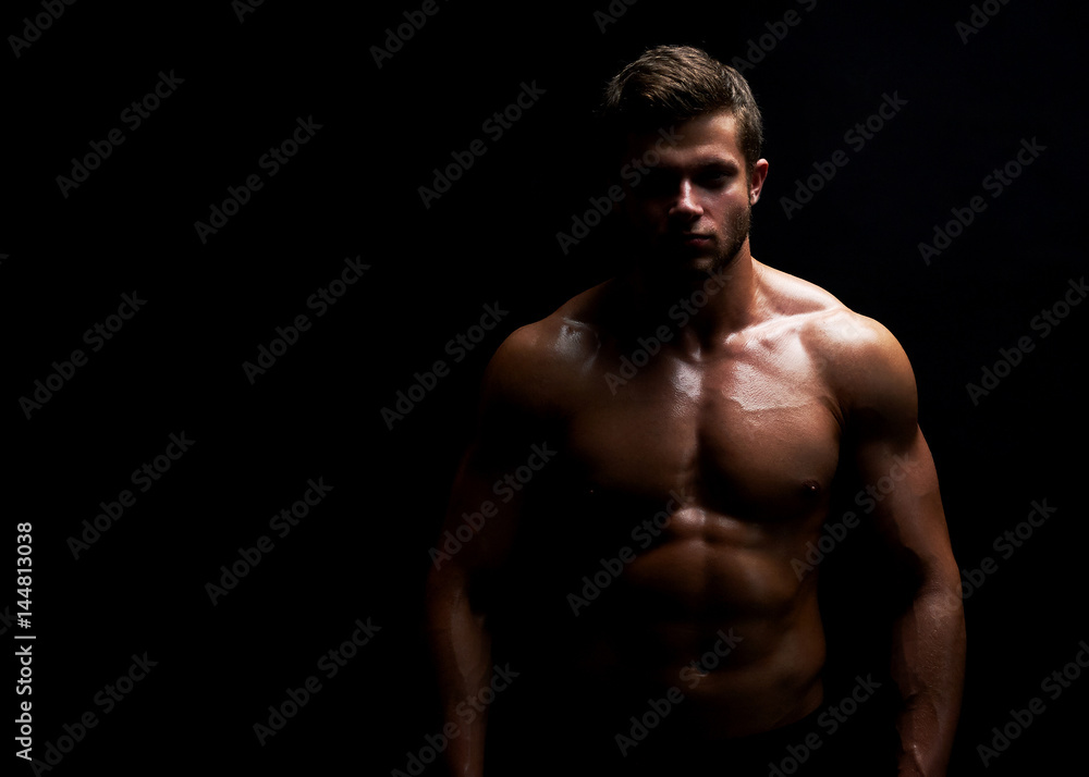 Horizontal portrait of a handsome young muscular fit and toned man posing confidently on black background copyspace workout crossfit fitness athleticism physique endurance confidence motivation. Horizontal portrait of a handsome young muscular fit and toned man posing confidently on black background copyspace workout crossfit fitness athleticism physique endurance confidence motivation.