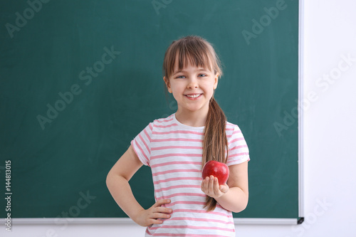 Happy schoolgirl standing w...