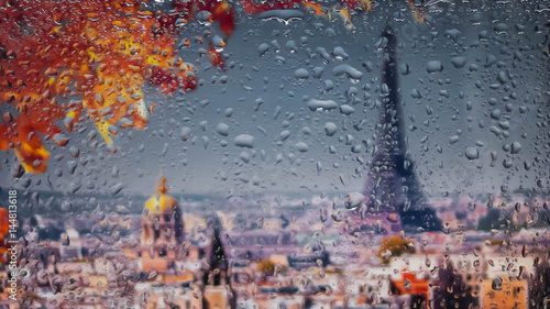 PARIS, FRANCE. A view of the city from a window from a high point during a rain. Rain drops on glass. Focus on drops