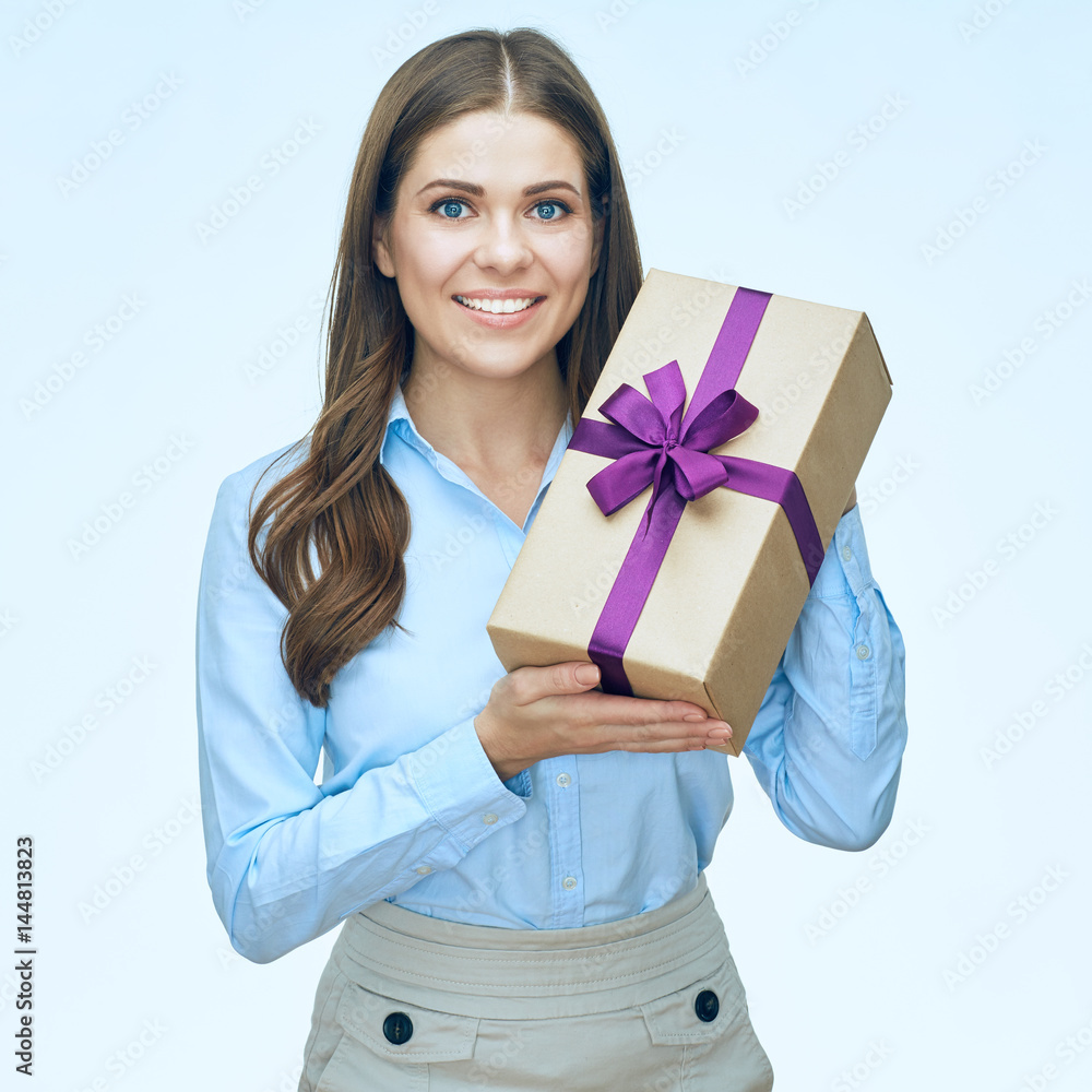 Smiling young woman with long hair holding gift box. Smiling young woman with long hair holding gift box.