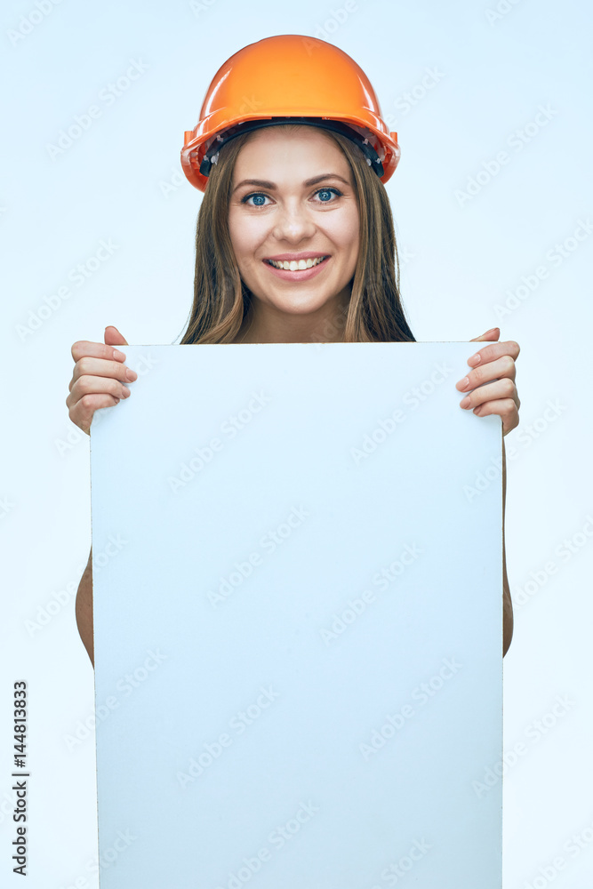 Smiling woman wearing protect builder helmet holding white banner with clear copy space. Smiling woman wearing protect builder helmet holding white banner with clear copy space.