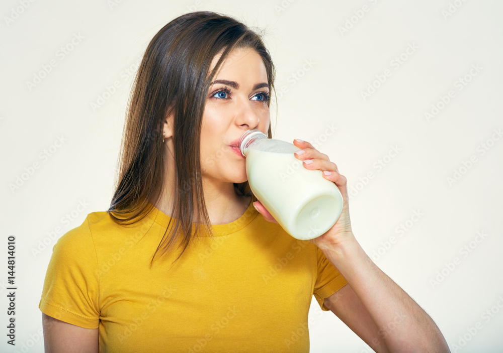 Young woman drinking milk from bottle. Young woman drinking milk from bottle.
