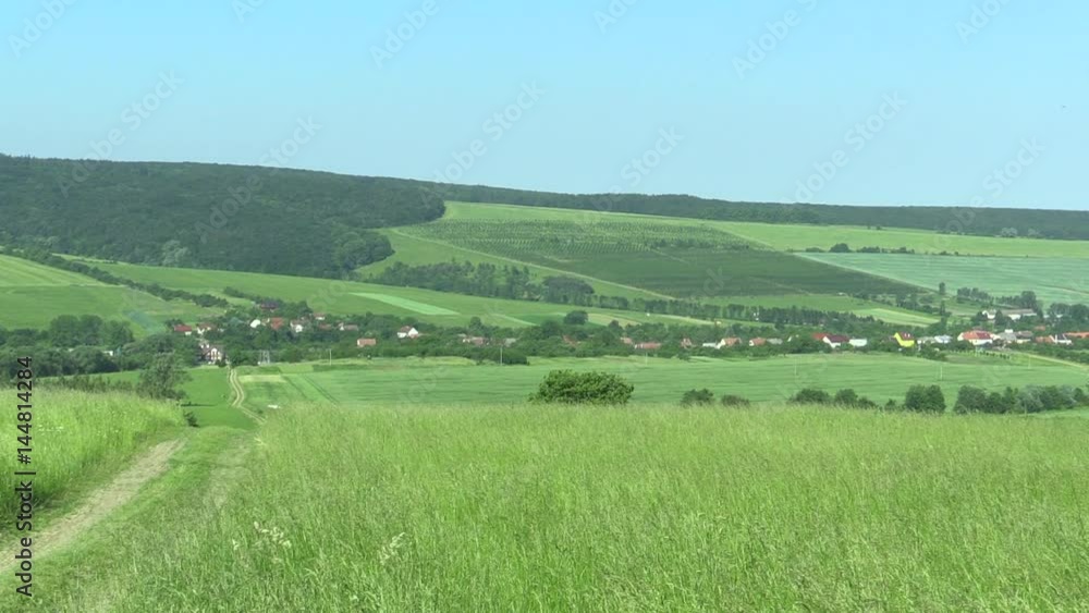 Green mountains (meadows), blue sky and village, the UNESCO biosphere reservation Bile Karpaty (White Carpathians), South Moravia, Czech Republic, Europe Green mountains (meadows), blue sky and village, the UNESCO biosphere reservation Bile Karpaty (White Carpathians), South Moravia, Czech Republic, Europe