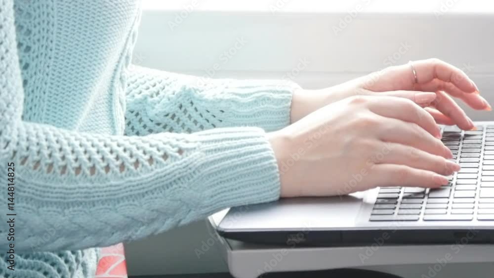 Young girl traveling in a train and using notebook. Female hands typing on keyboard of laptop during riding on railroad. Attractive woman chatting with friends. Close up Slow motion Young girl traveling in a train and using notebook. Female hands typing on keyboard of laptop during riding on railroad. Attractive woman chatting with friends. Close up Slow motion