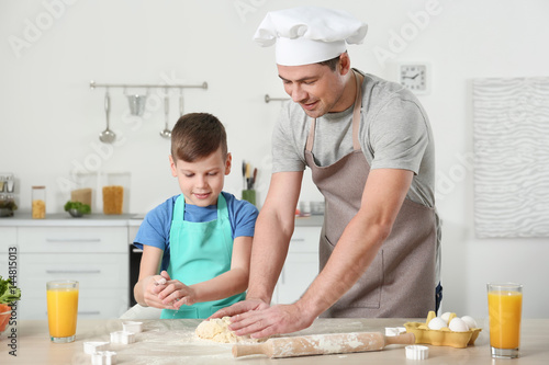 Father and son cooking together in kitchen