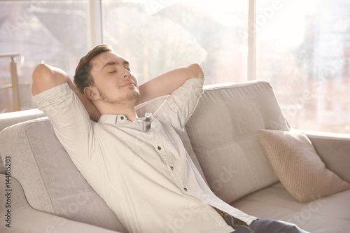 Happy young man resting on ...