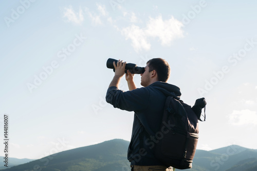 Man tourist with binocular 