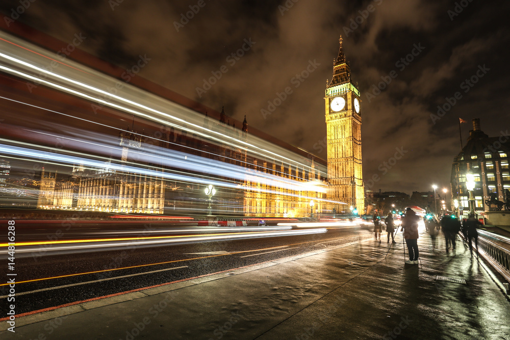 Big Ben London Parliament building by night time with traffic