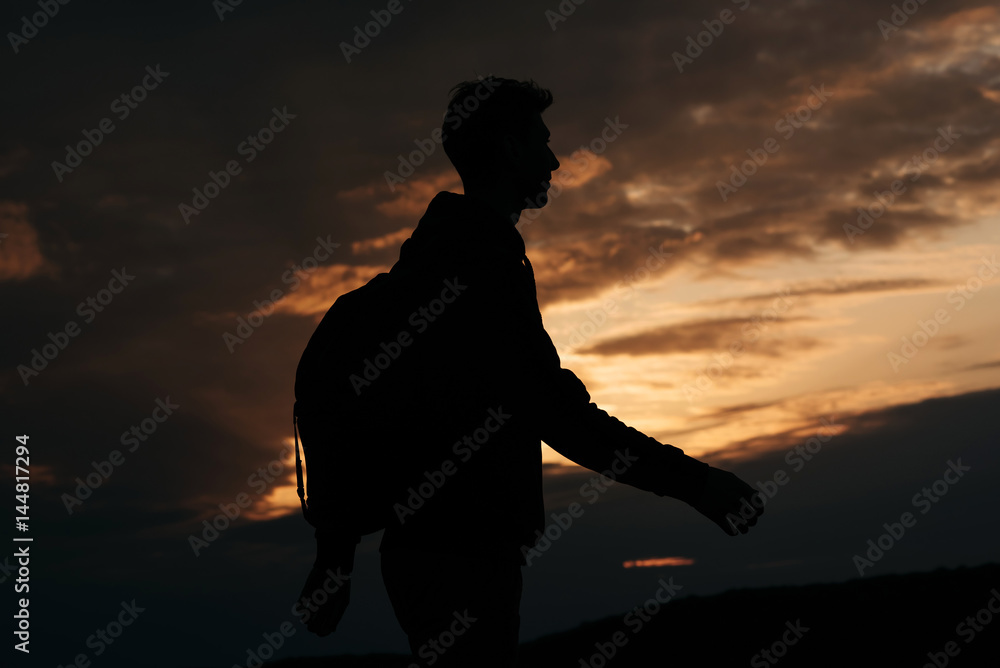Silhouette of tourist at sunset