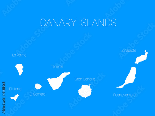 Map of Canary Islands, Spain, with labels of each island - El Hierro, La Palma, La Gomera, Tenerife, Gran Canaria, Fuerteventura and Lanzarote. White vector silhouette on blue background. photo