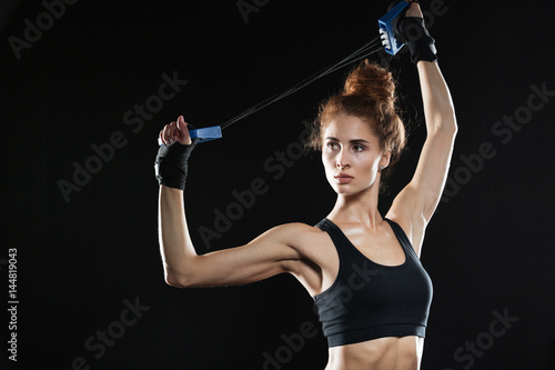 Young Female fighter using expander