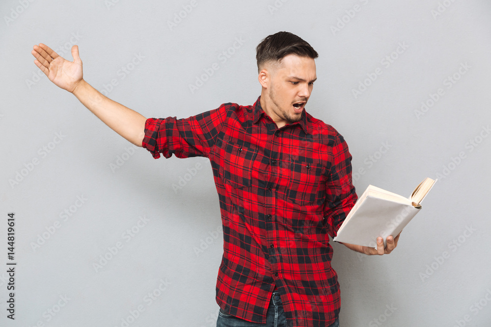 Concentrated man rehearses with book Concentrated man rehearses with book