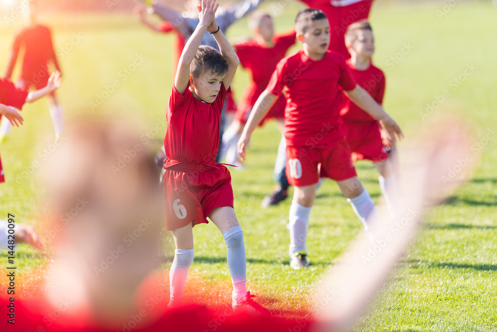 Obraz premium Kids soccer football - children players exercising before match on soccer field