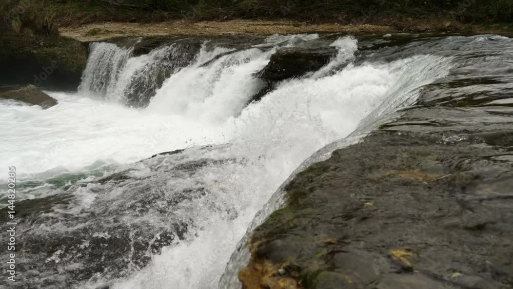 Wide shot of slow motion water floating down a cascade of a river, in 4K Wide shot of slow motion water floating down a cascade of a river, in 4K