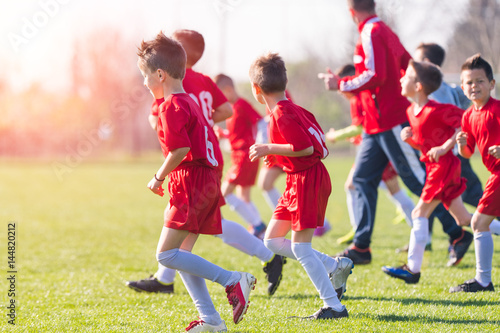 Kids soccer football - children players exercising before match on soccer field photo