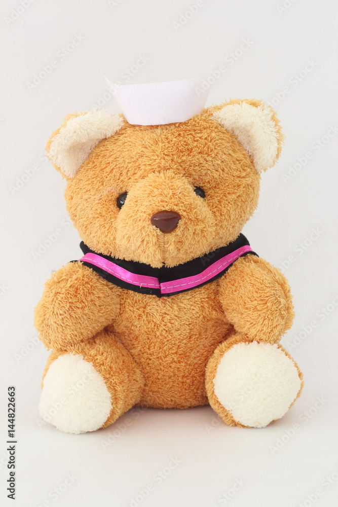 Fototapeta premium Teddy bear wearing a nurse hat on a white background.