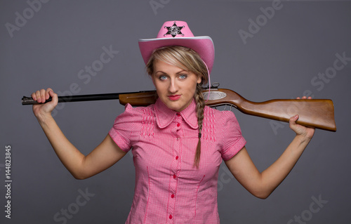 Photos Attractive cawbow girl with shot gun over back
