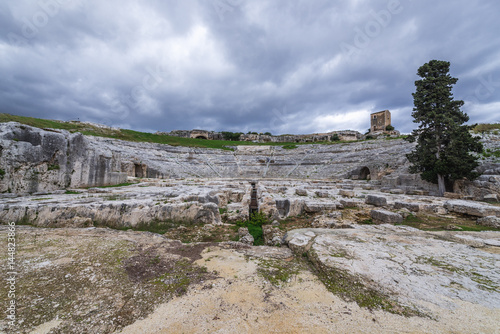 View of stage and auditorium of Greek theater in Neapolis Archaeological Park in Syracuse, Sicily Island of Italy
