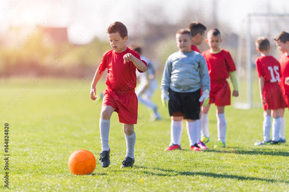 Kids soccer football - children players match on soccer field Kids soccer football - children players match on soccer field