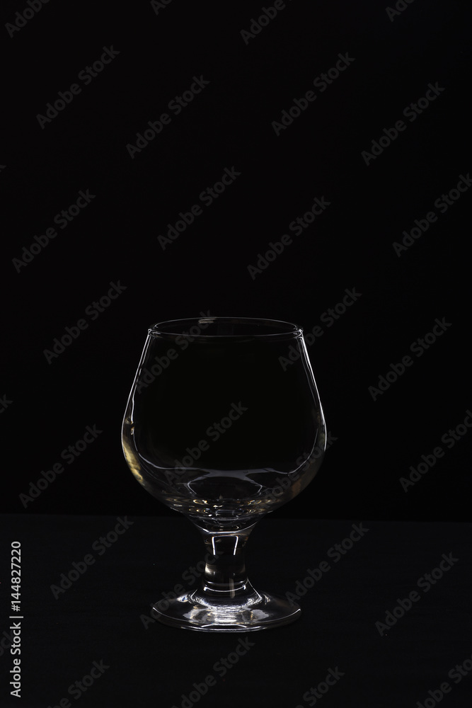 empty glass for cognac or whiskey isolated on black background empty glass for cognac or whiskey isolated on black background