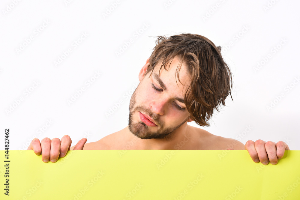 Caucasian sexy young macho holding yellow paper sheet Caucasian sexy young macho holding yellow paper sheet
