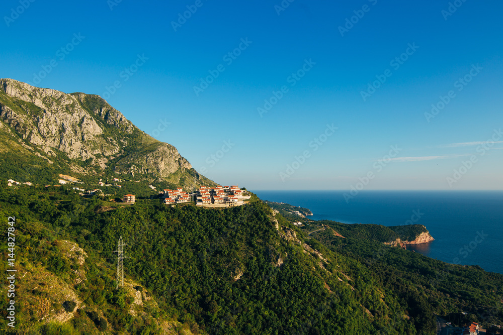 Russian village on the mountain in Montenegro over the island of Sveti Stefan.