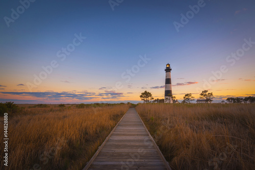 Boardwalk leading to Bodie Island Lighthouse at sunset 