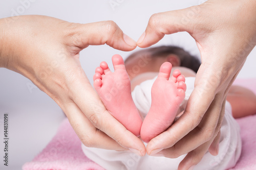 baby feet in mother hands,hearth shape