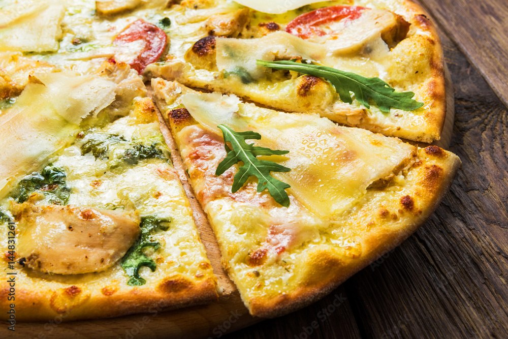 Delicious pizza with chicken, parmesan and fresh arugula Delicious pizza with chicken, parmesan and fresh arugula