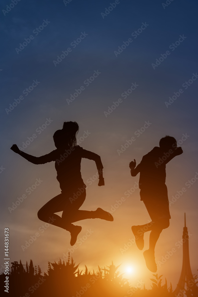 silhouette of a happy people and sunset