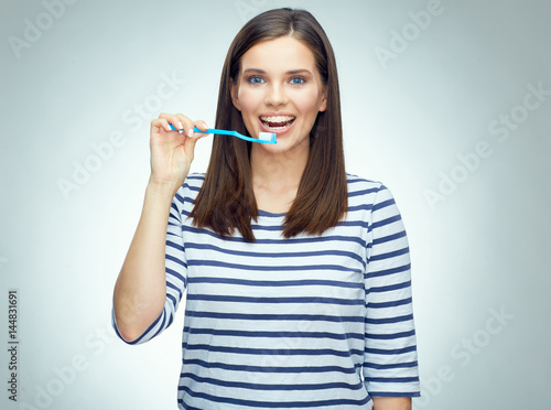 Fototapeta Naklejka Na Ścianę i Meble -  Smiling girl with brace brushing teeth.