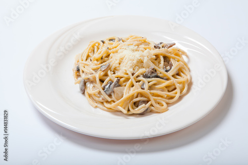 Italian pasta with mushrooms on a white plate