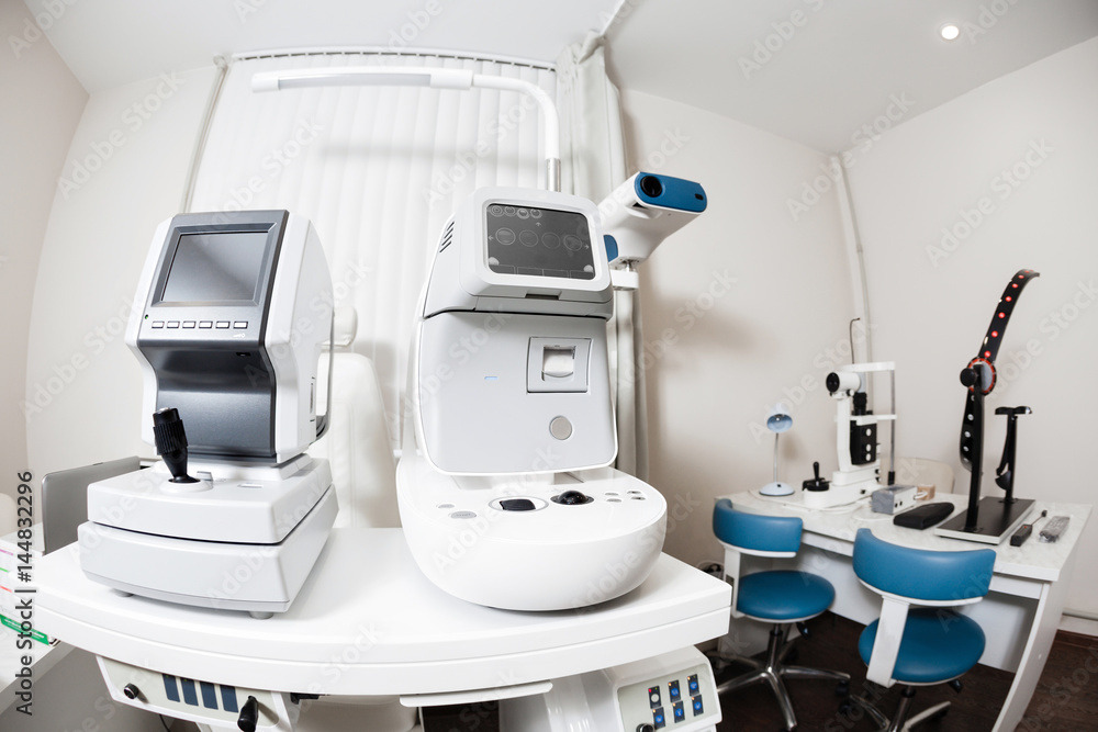 Close up of professional eye testing equipment. Modern eye testing device standing in the lab. Tonometer in ophthalmologist's office Close up of professional eye testing equipment. Modern eye testing device standing in the lab. Tonometer in ophthalmologist's office